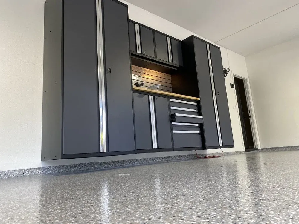 Modular metal garage storage cabinet system installed over an epoxy-coated floor