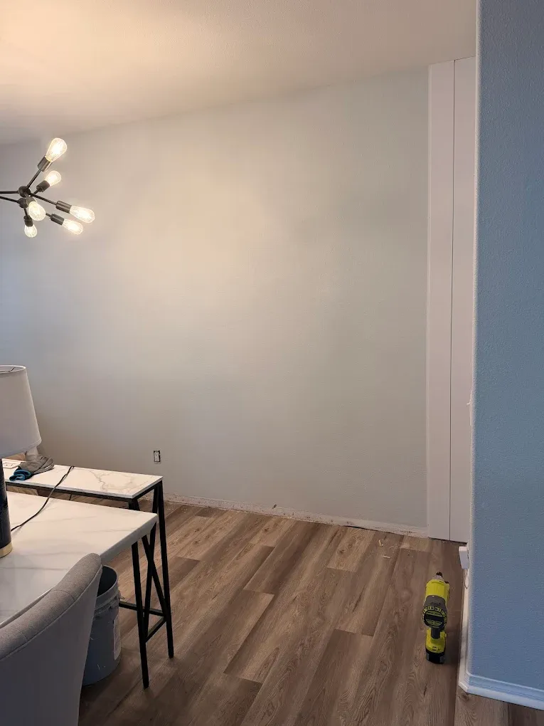 Luxury vinyl plank flooring and fresh interior paint in a finished room